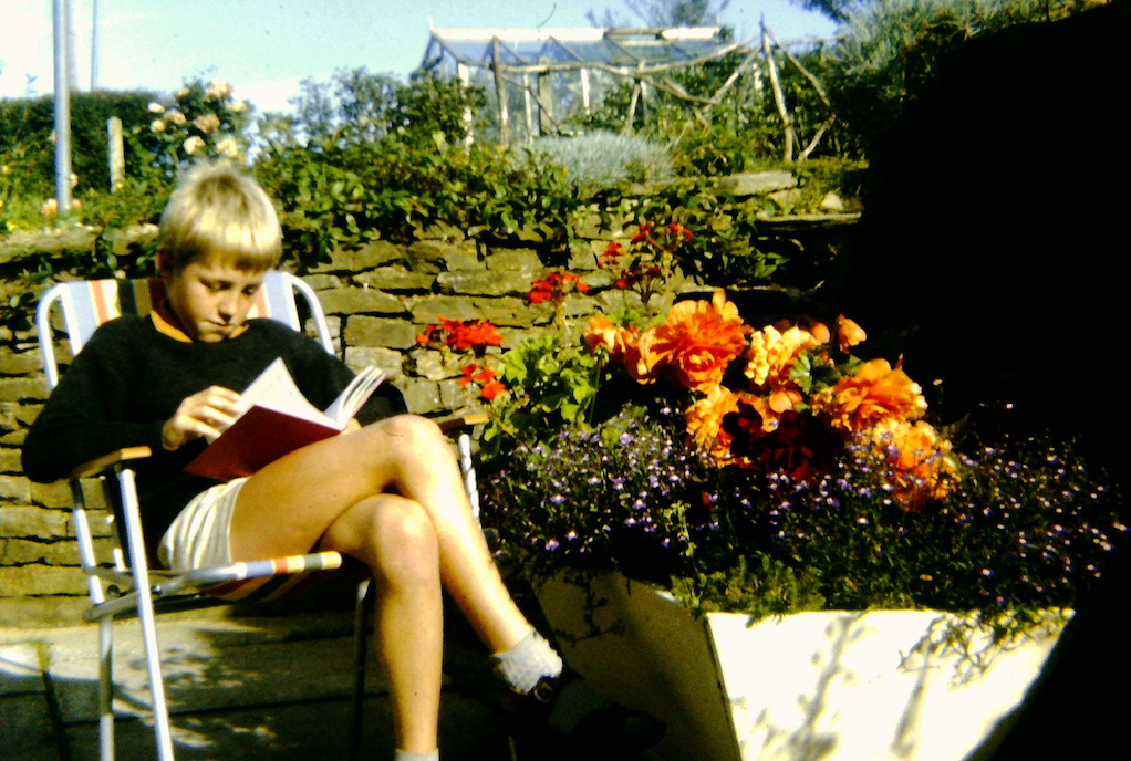 boy reading in garden